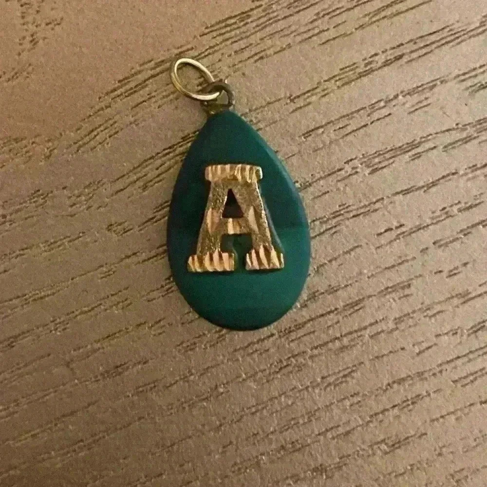 18k Gold A Pendant Green Background